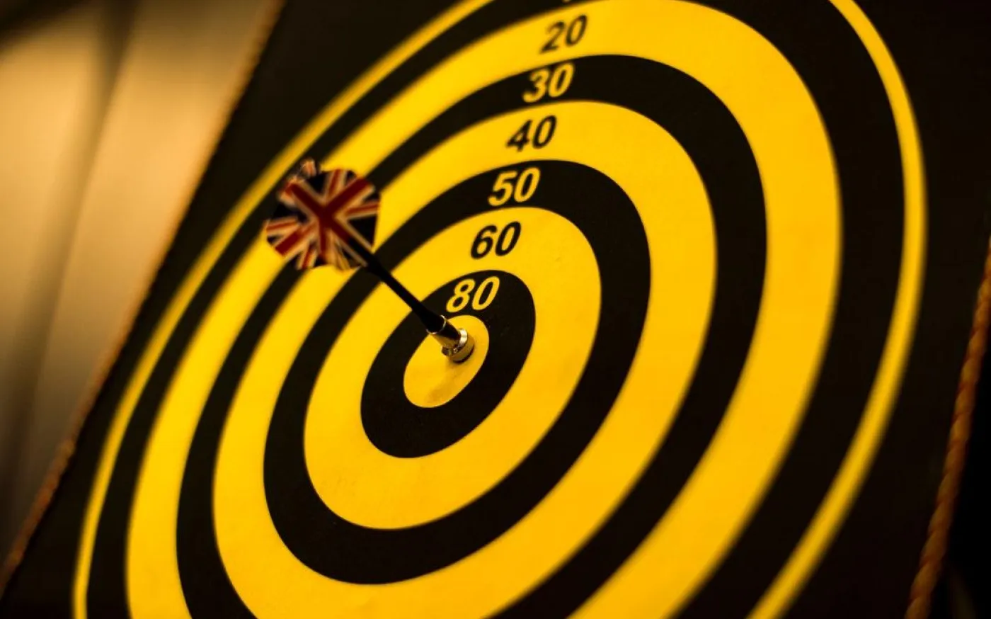 A dart is perfectly positioned in the center of a bullseye target, symbolizing precision and accuracy.